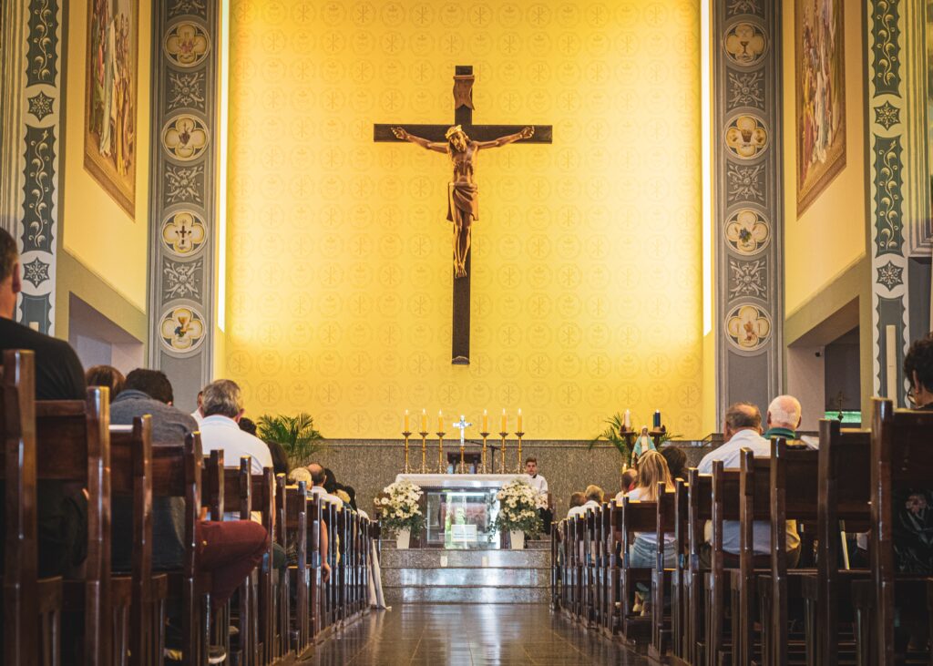 People praying in Church before Mass