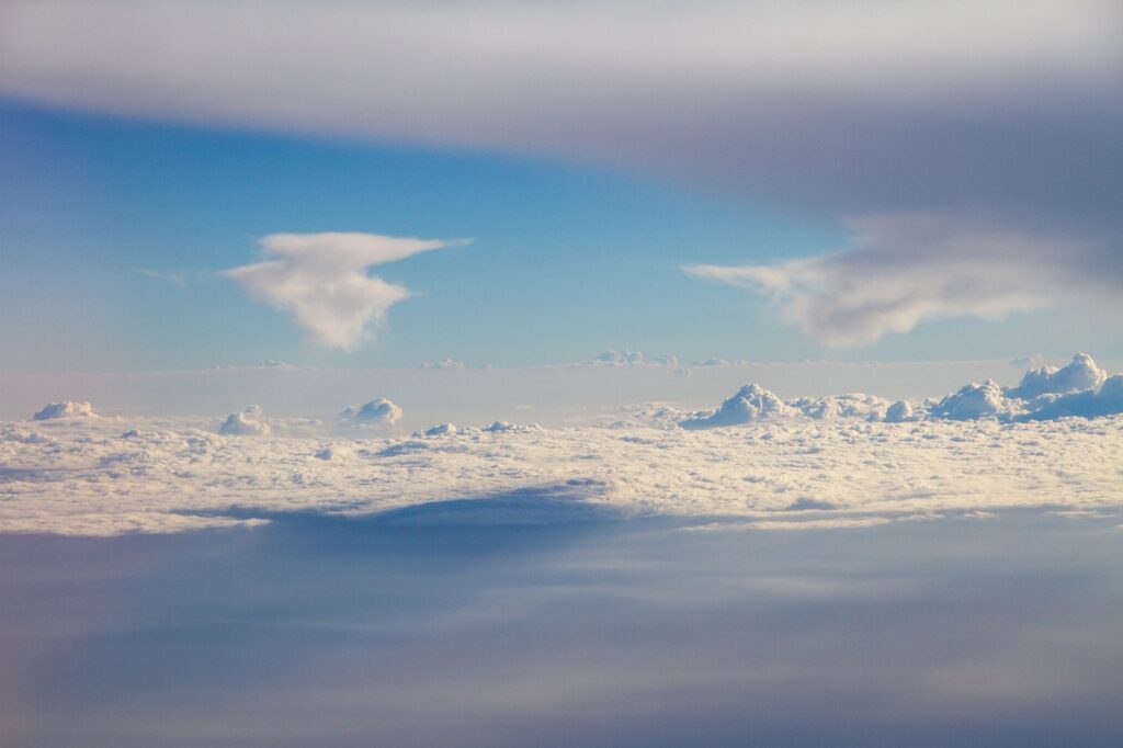 Heavenly clouds in the blue sky with a cloud hovering over them